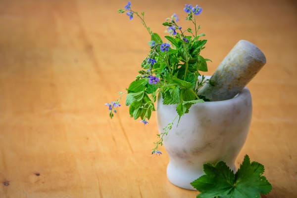 herbs inside a mortar and pestle