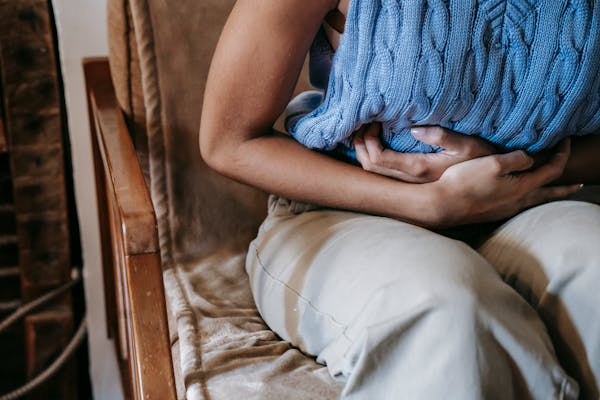 a woman suffering from abdominal pain